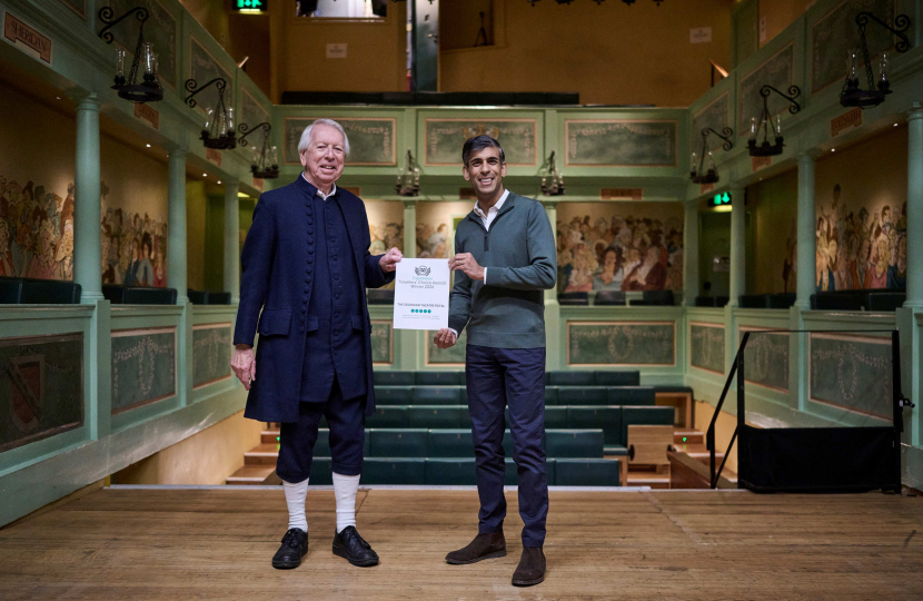 Rishi Sunak MP presenting TripAdvisor award to volunteer tour guide Gerry Broadbent