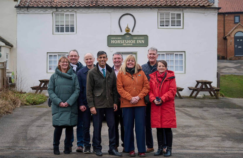 Rishi with members of local community outside The Horseshoe Inn