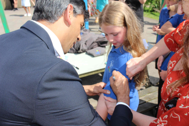 Rishi Sunak signs a leaver's shirt at Askrigg Primary School