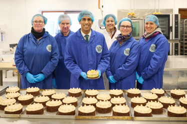 Rishi with Gluten Free Kitchen staff and traditional Simnel cakes