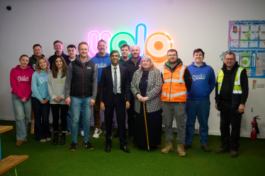 Rishi Sunak with staff at YOLO Inc