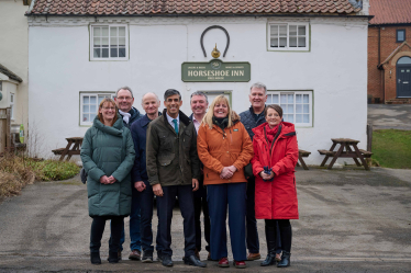 Rishi with members of local community outside The Horseshoe Inn